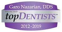 The image shows a logo with text that reads  GARO NAZARIAN, DDS  followed by the words  TOPDENTISTS   2013-2019 SELECTED,  and below that, there s a purple background with white text stating  TOPDENTISTS  .  The logo is accompanied by a badge or emblem with the same name  TOPDENTISTS    in a stylized font.