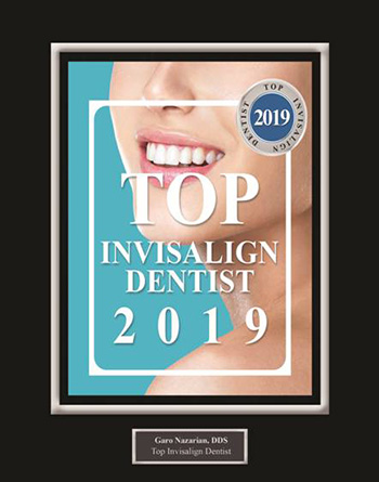 The image displays a framed certificate with text that reads  TOP INVISALIGN DENTIST 2019  along with the name  CareNations Dental Clinic  at the bottom, indicating an award for excellence in invisible braces treatment for the year 2019.