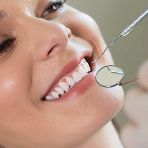 A woman receiving dental care with a smiling expression.